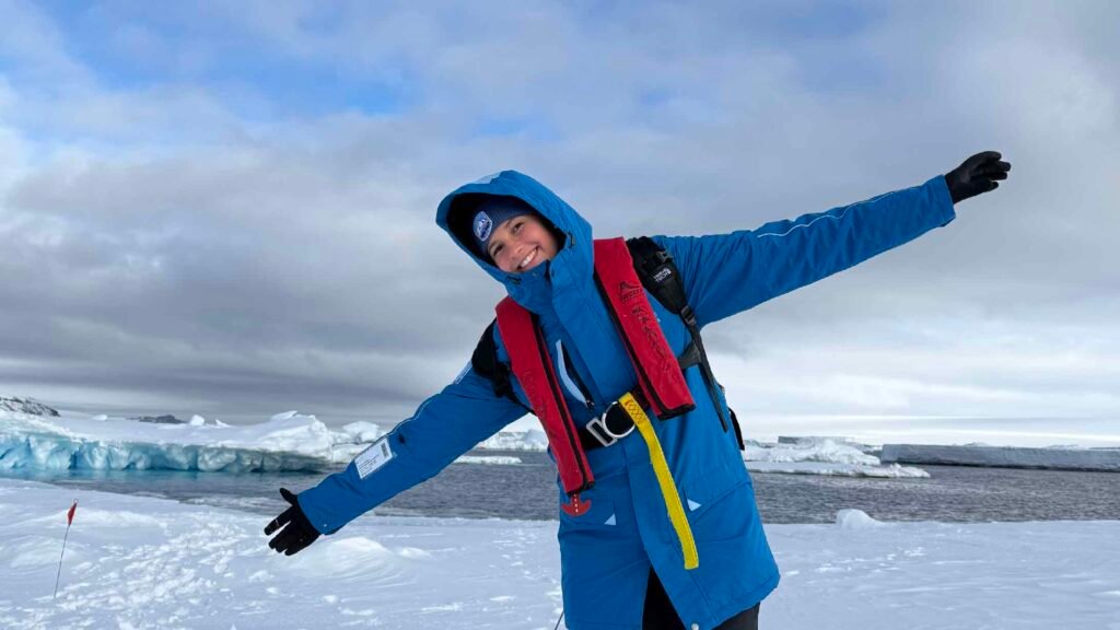 woman in pack of iceberg in antarctica laughing